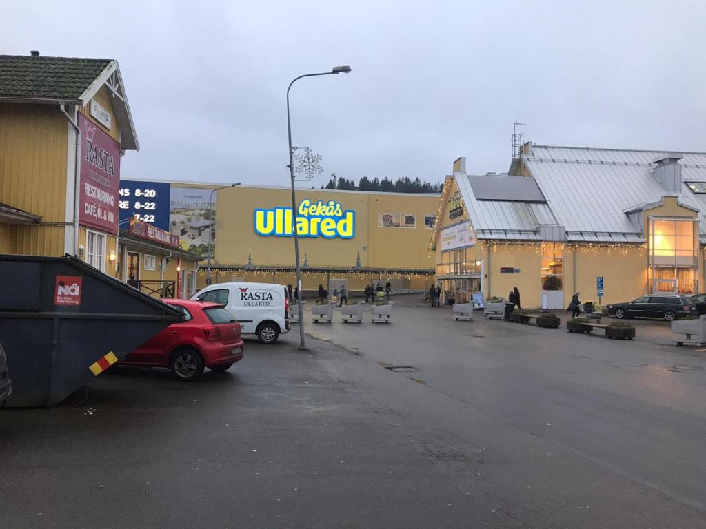 a parking lot in front of a building with a sign at Rum nära Gekås in Ullared