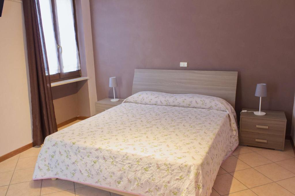 a bedroom with a bed and two night stands at B&B Casa a colori in Verona