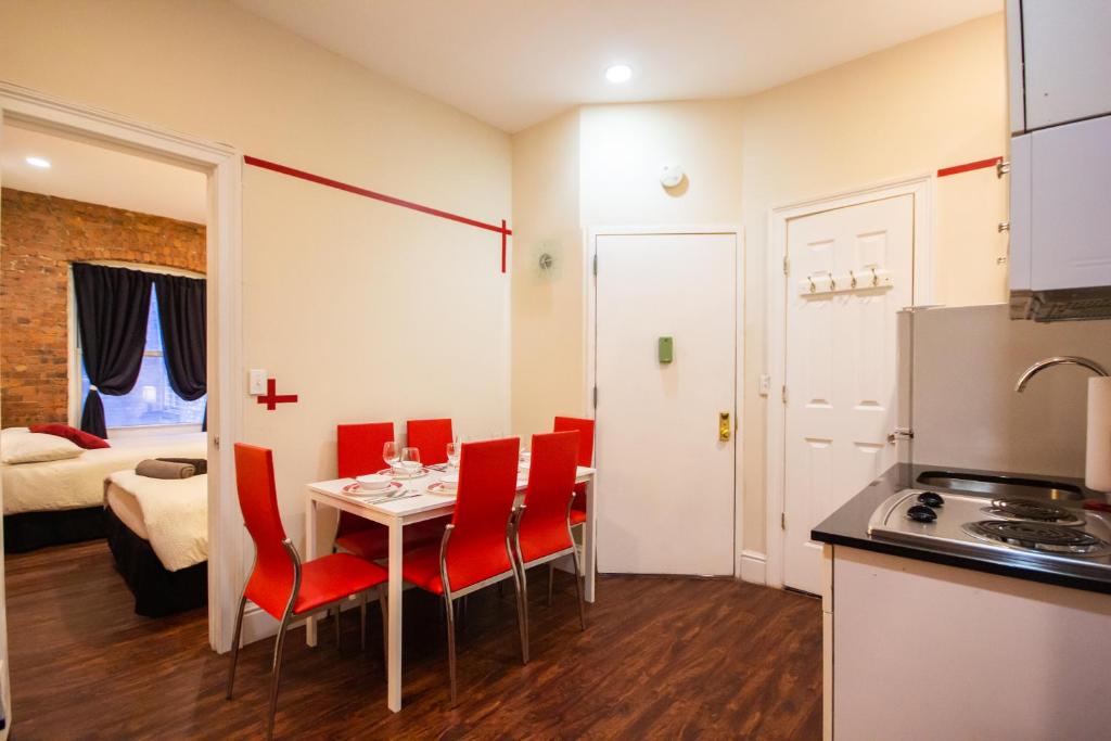 a kitchen and dining room with a table and chairs at STUDIO PLUS - 2 Bedroom Apartment in Midtown in New York