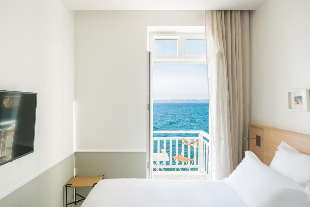 a bedroom with a window with a view of the ocean at Les Bords De Mer in Marseille