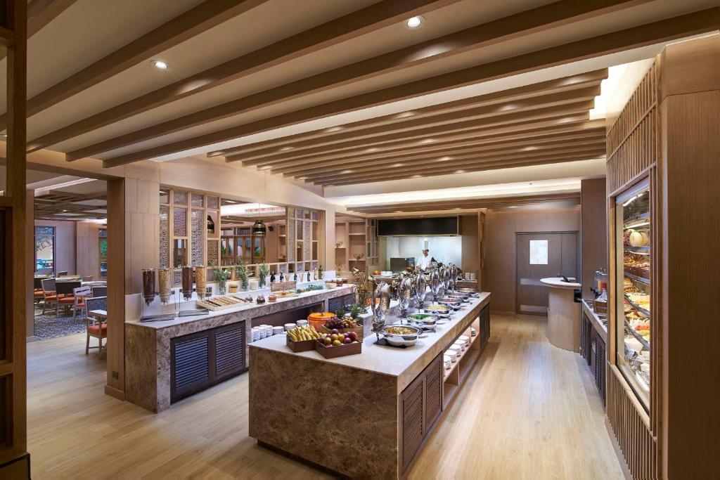 a large room with a bar with a lot of food at Amari Vogue Krabi in Tab Kaek Beach
