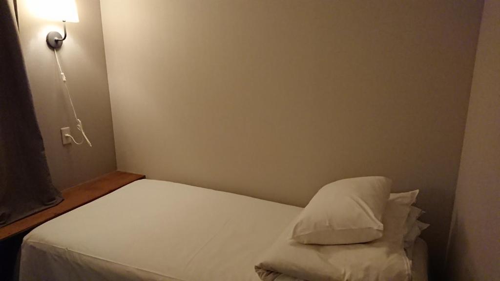 Postel nebo postele na pokoji v ubytování Guest House Yadomaru
