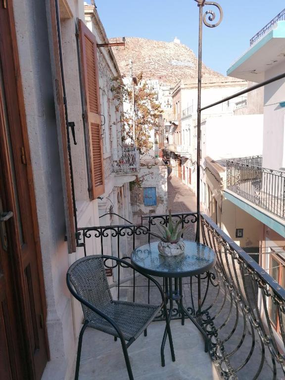 a patio with a table and chairs on a balcony at THEOS APARTMENTS in Kalymnos