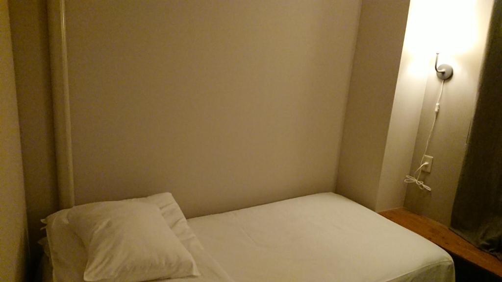 Postel nebo postele na pokoji v ubytování Guest House Yadomaru