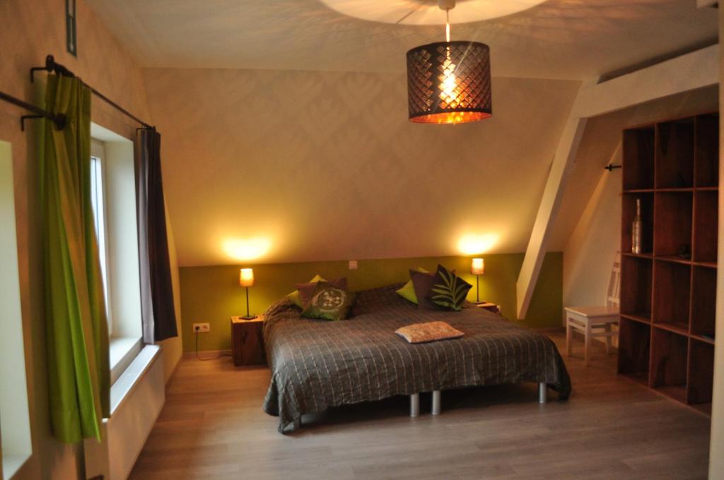 Un pat sau paturi într-o cameră la Het Takketiele Huis