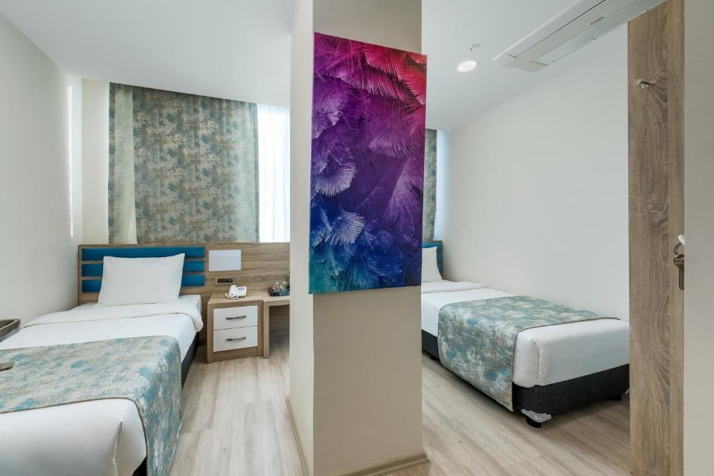 Postel nebo postele na pokoji v ubytování Anelli Hotel