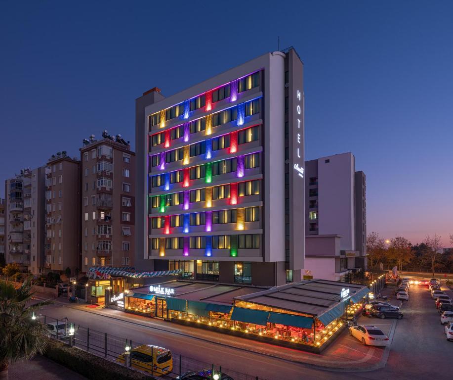a building with colorful lights in a parking lot at Anelli Hotel in Antalya