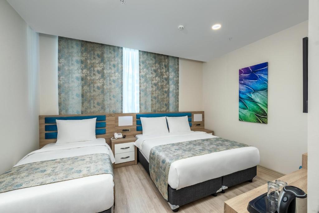 Postel nebo postele na pokoji v ubytování Anelli Hotel