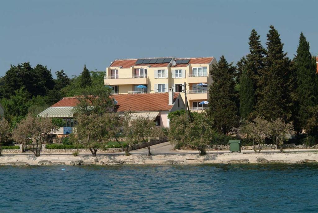a building on the shore of a body of water at Apartman Basioli1 in Zadar