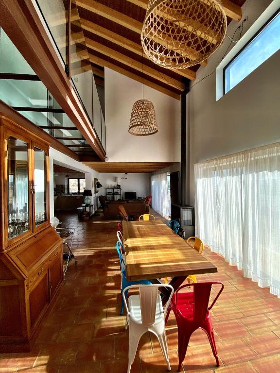 a dining room with a wooden table and chairs at Cortijo Jamaro Boutique in Cehegín