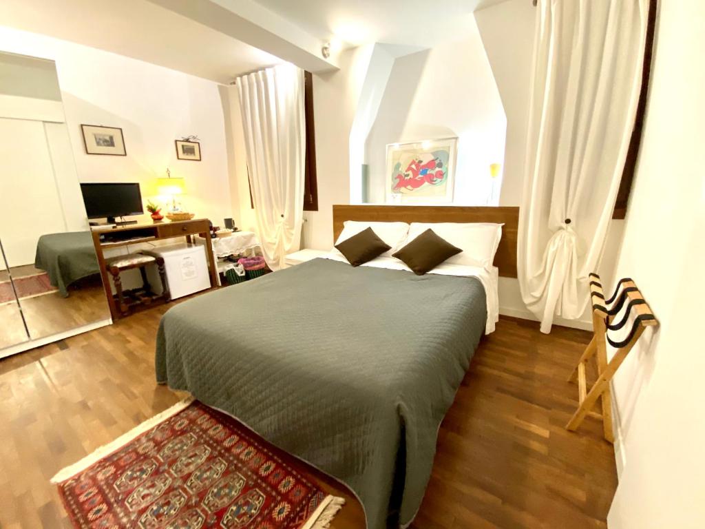 a bedroom with a bed and a desk at San Tomà in Venice
