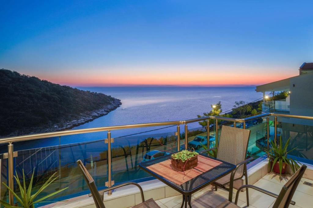 a balcony with a table and a view of the ocean at Villa Irene in Skala Marion