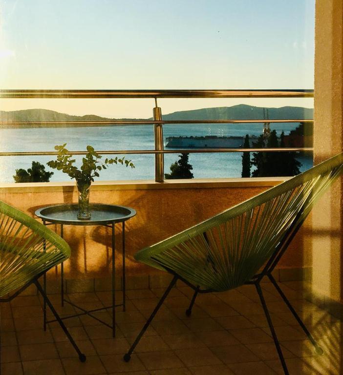 a balcony with a table and a view of the water at Trogir family space 90m2 in Trogir