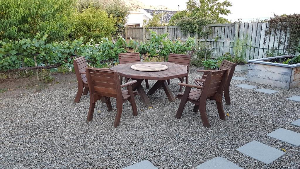 a wooden table and chairs on a gravel patio at 128 on Hazlett in Clyde