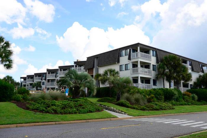 a large apartment building on the side of a street at Matilda's at Ocean Forest Villas in Myrtle Beach