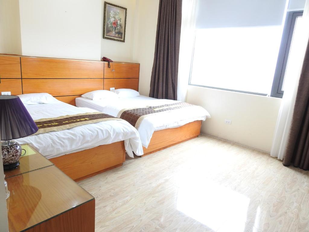 Postel nebo postele na pokoji v ubytování An Phú Nguyễn Hoàng Hotel