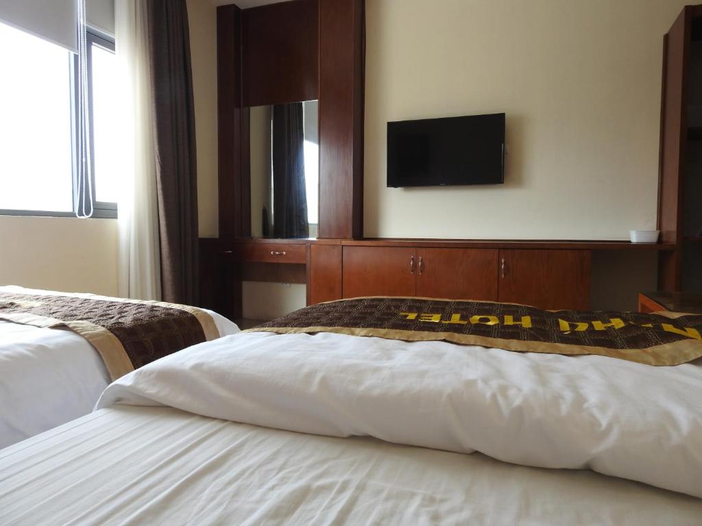 Postel nebo postele na pokoji v ubytování An Phú Nguyễn Hoàng Hotel