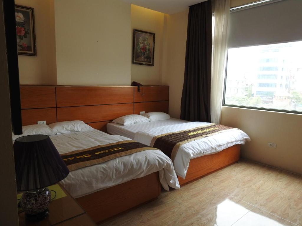 Postel nebo postele na pokoji v ubytování An Phú Nguyễn Hoàng Hotel