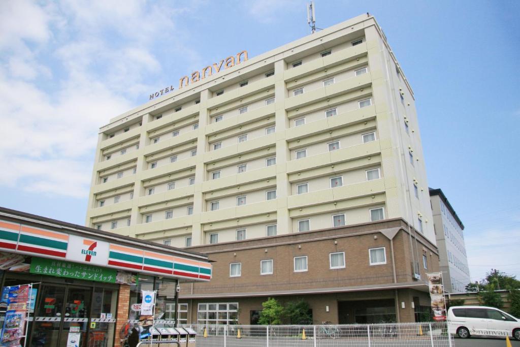 a large building with a sign on top of it at Hotel nanvan Yaizu in Yaizu