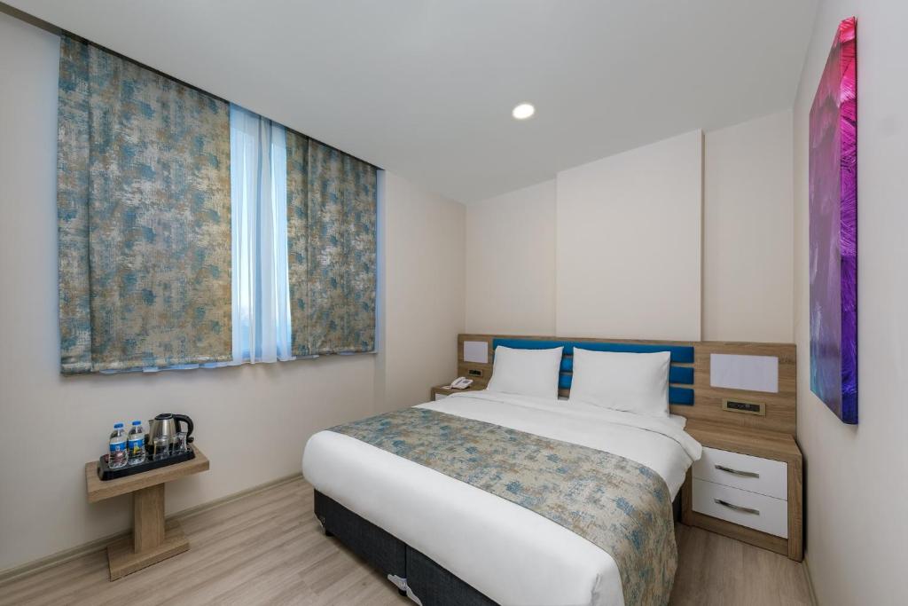 Postel nebo postele na pokoji v ubytování Anelli Hotel
