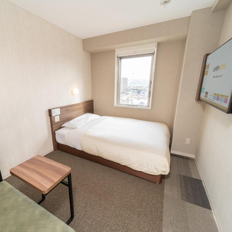 Postel nebo postele na pokoji v ubytování Super Hotel Joetsu Myoko-Eki Nishiguchi