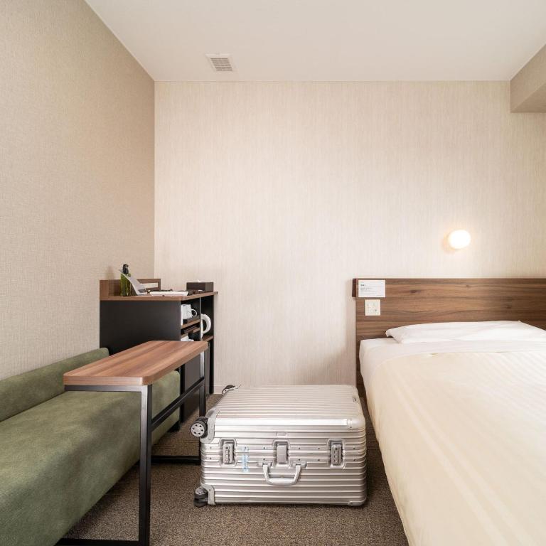 Postel nebo postele na pokoji v ubytování Super Hotel Joetsu Myoko-Eki Nishiguchi