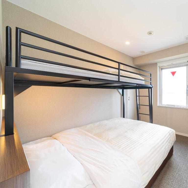 Postel nebo postele na pokoji v ubytování Super Hotel Joetsu Myoko-Eki Nishiguchi