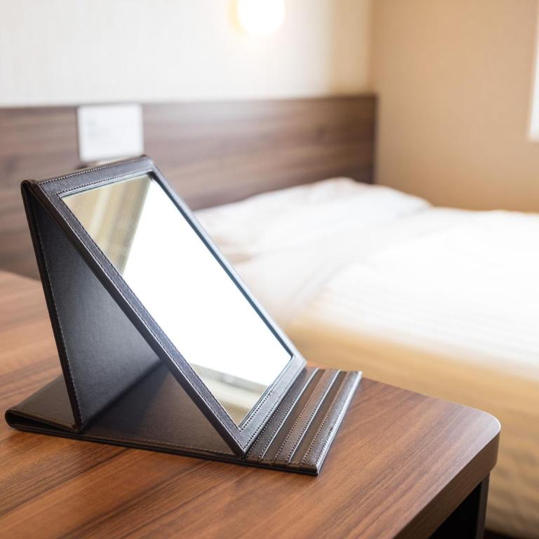 Postel nebo postele na pokoji v ubytování Super Hotel Joetsu Myoko-Eki Nishiguchi