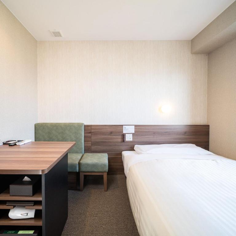 Postel nebo postele na pokoji v ubytování Super Hotel Joetsu Myoko-Eki Nishiguchi