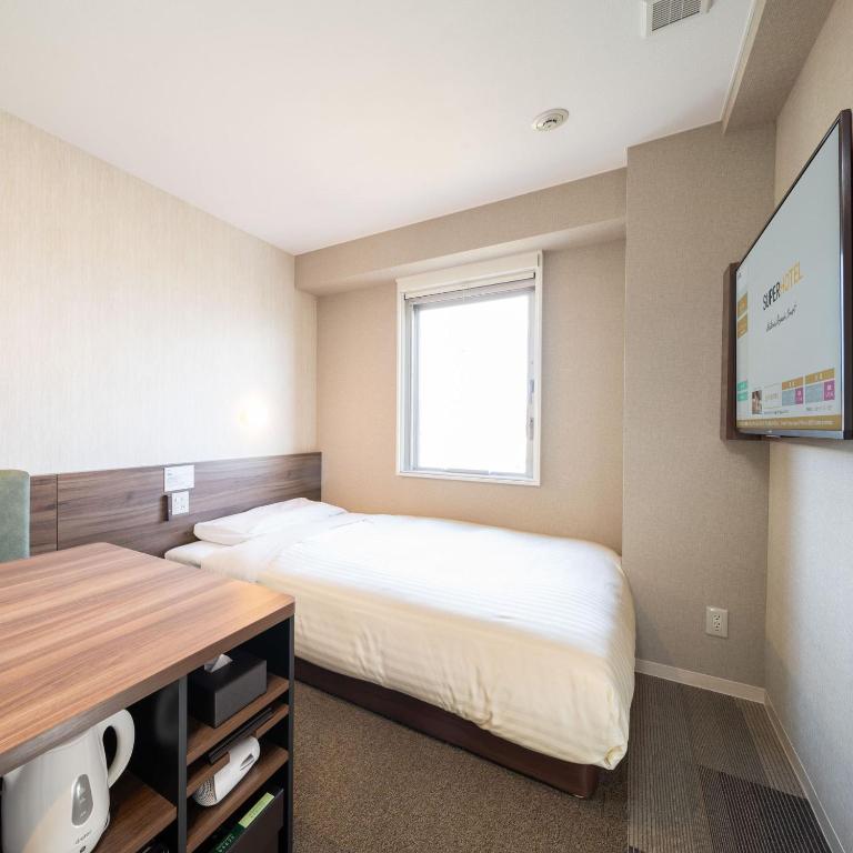 Postel nebo postele na pokoji v ubytování Super Hotel Joetsu Myoko-Eki Nishiguchi