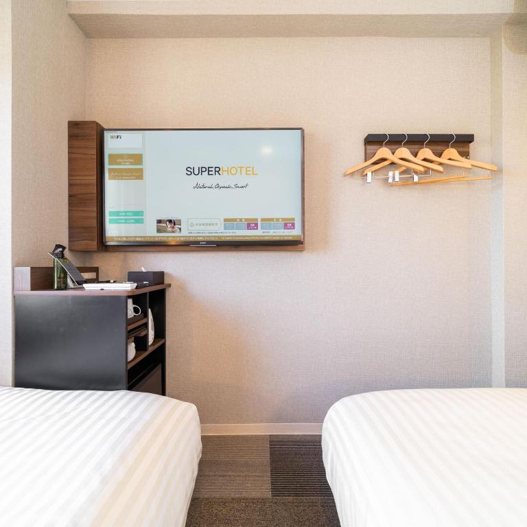Postel nebo postele na pokoji v ubytování Super Hotel Joetsu Myoko-Eki Nishiguchi