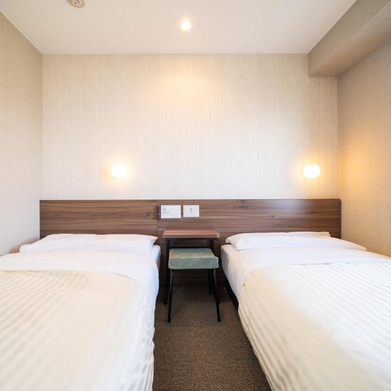 Postel nebo postele na pokoji v ubytování Super Hotel Joetsu Myoko-Eki Nishiguchi