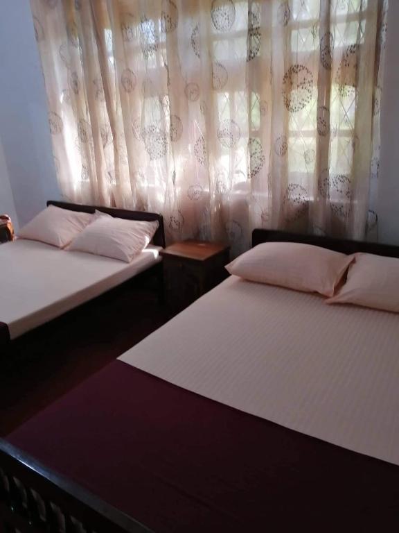 Postel nebo postele na pokoji v ubytování Olivia HomeStay
