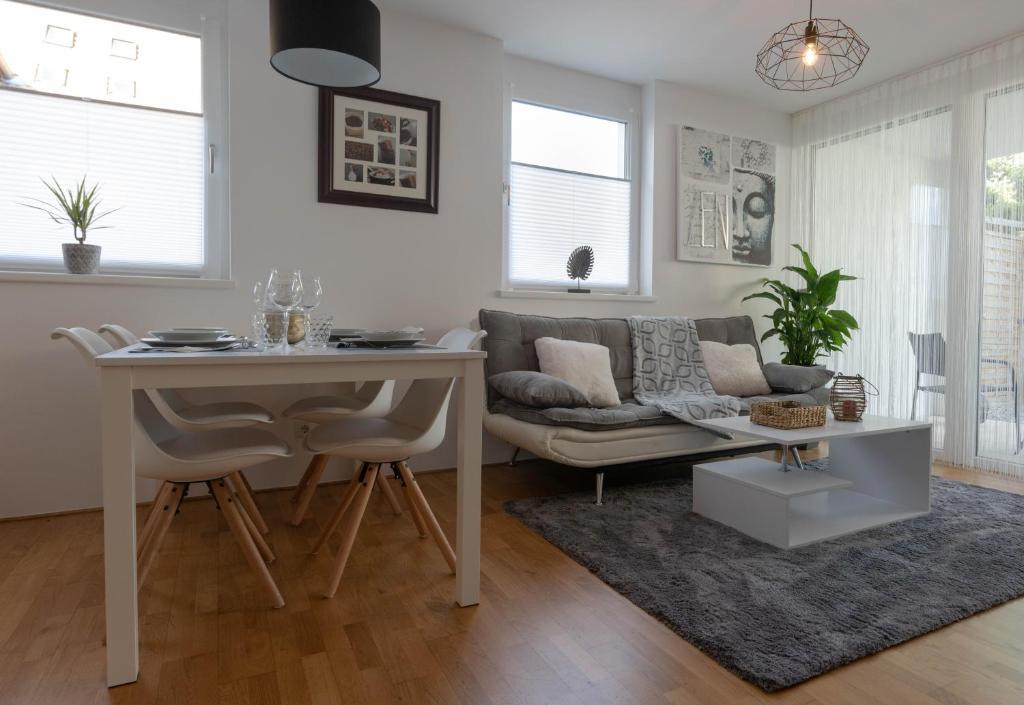 a living room with a table and a couch at Apartment Mama Lisa in Lauterach