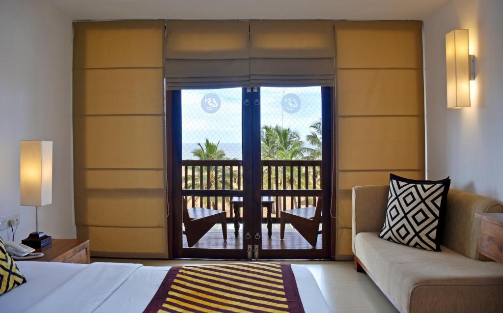 Postel nebo postele na pokoji v ubytování Goldi Sands Hotel