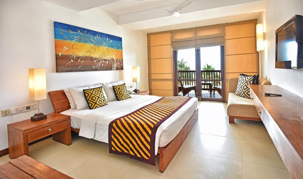 Postel nebo postele na pokoji v ubytování Goldi Sands Hotel