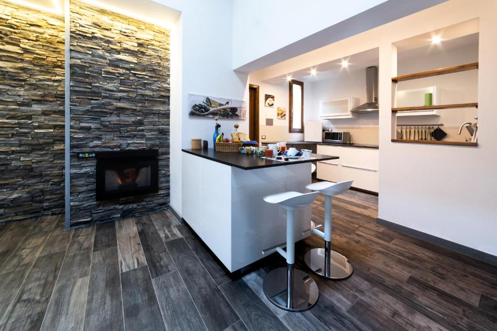 a kitchen and living room with a fireplace at Medici Soderini in Florence