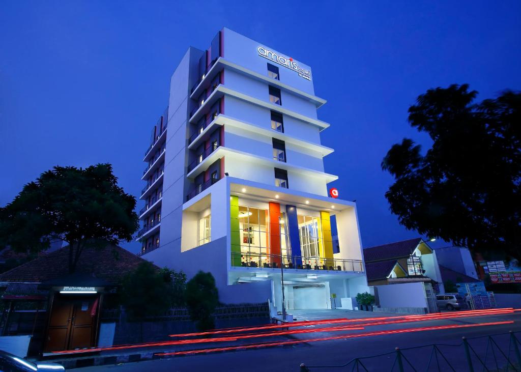 a white building with a sign on it at night at Amaris Hotel Dr. Susilo Grogol in Jakarta