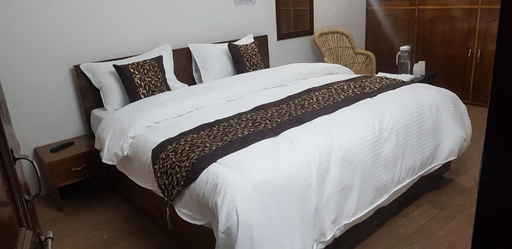 Postel nebo postele na pokoji v ubytování SHIVANI HOME STAY