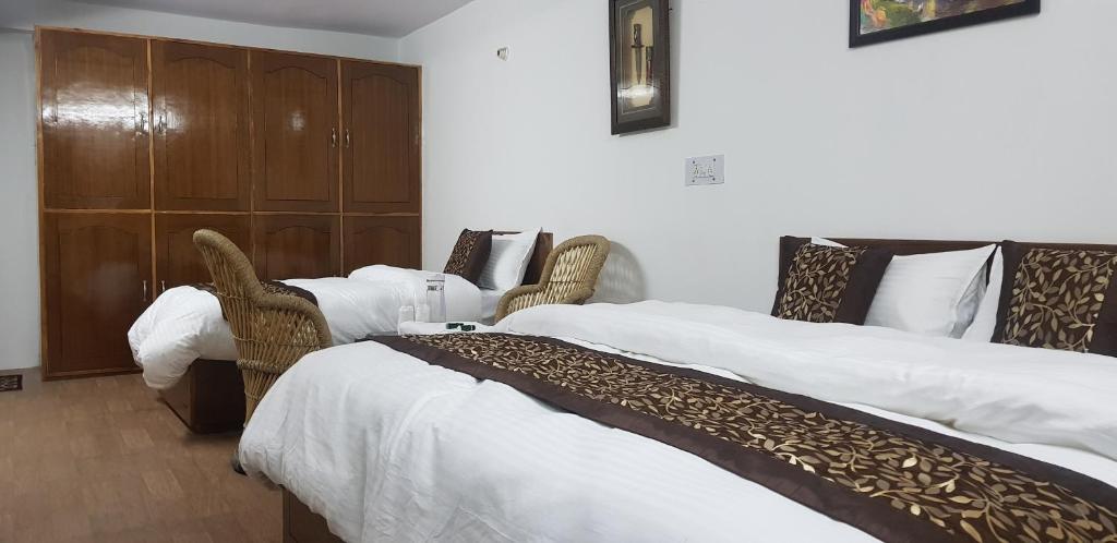 Postel nebo postele na pokoji v ubytování SHIVANI HOME STAY