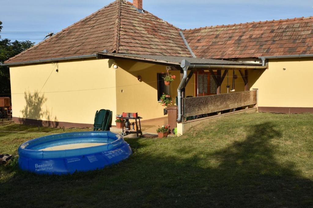 a house with a swimming pool in the yard at Huszár Tanya in Keszeg