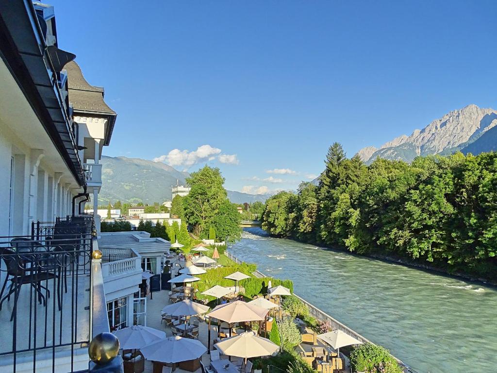a large body of water with trees and houses at Grandhotel Lienz in Lienz