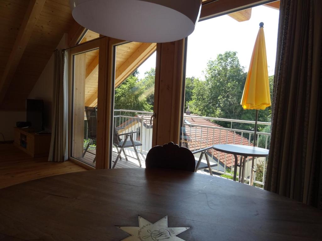 a star on a table in a room with a balcony at Ferienwohnung Seidlpark im Haus Ecker in Murnau am Staffelsee