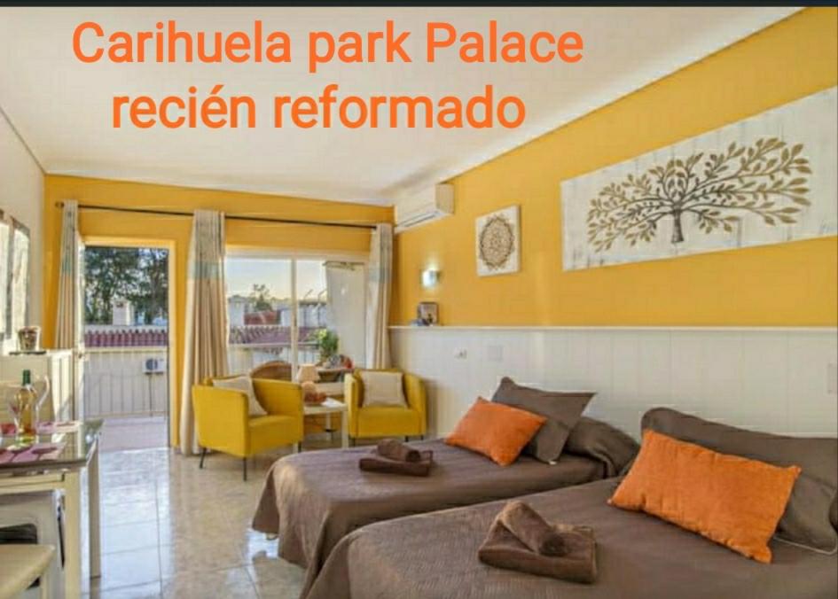 a hotel room with two beds and a living room at Casa María Carihuela Park Palace in Torremolinos