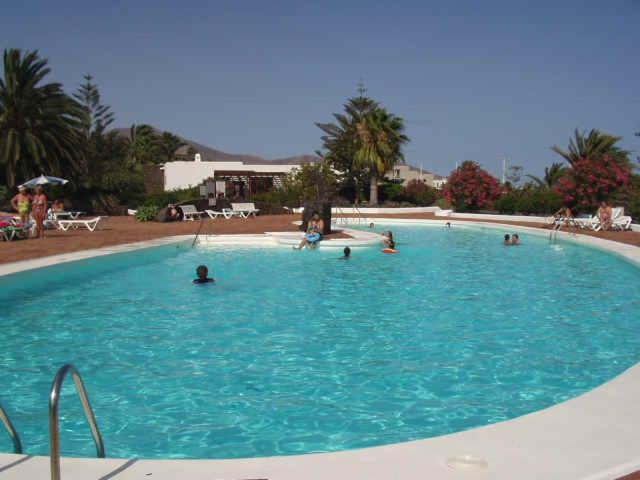 a large swimming pool with people in the water at Casas del Sol Lanzarote in Playa Blanca