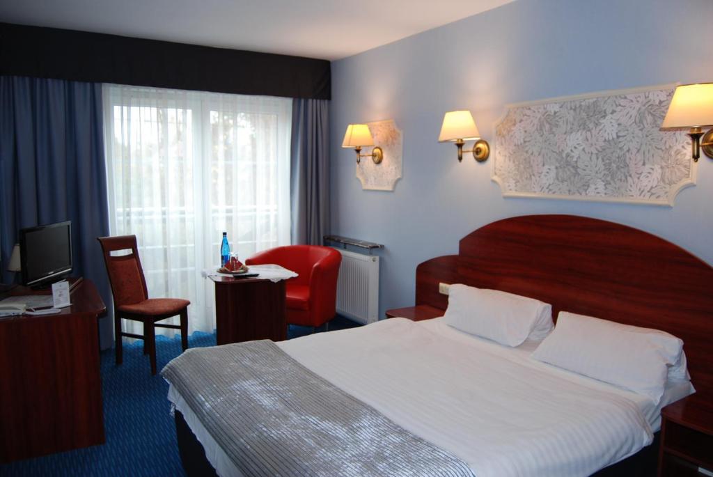 Postel nebo postele na pokoji v ubytování Amigo Hotel
