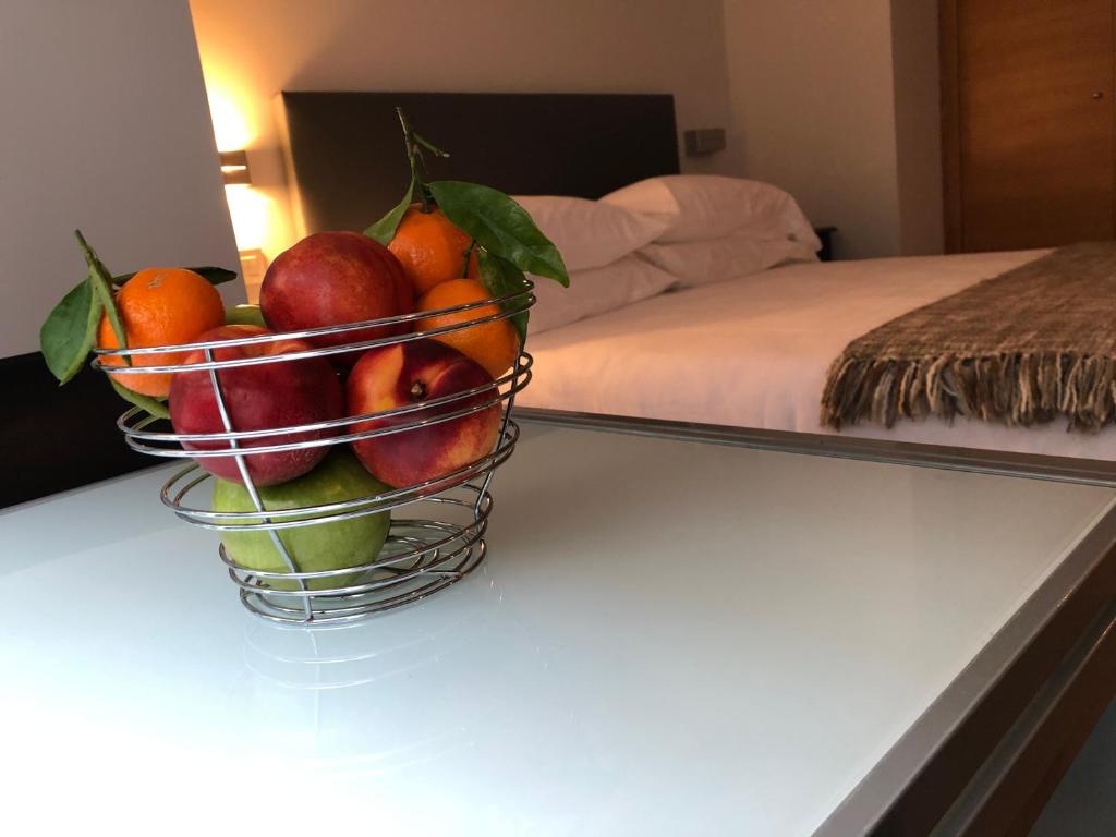 a basket of fruit on a table in a bedroom at Contemporaneo y Centrico in Vigo