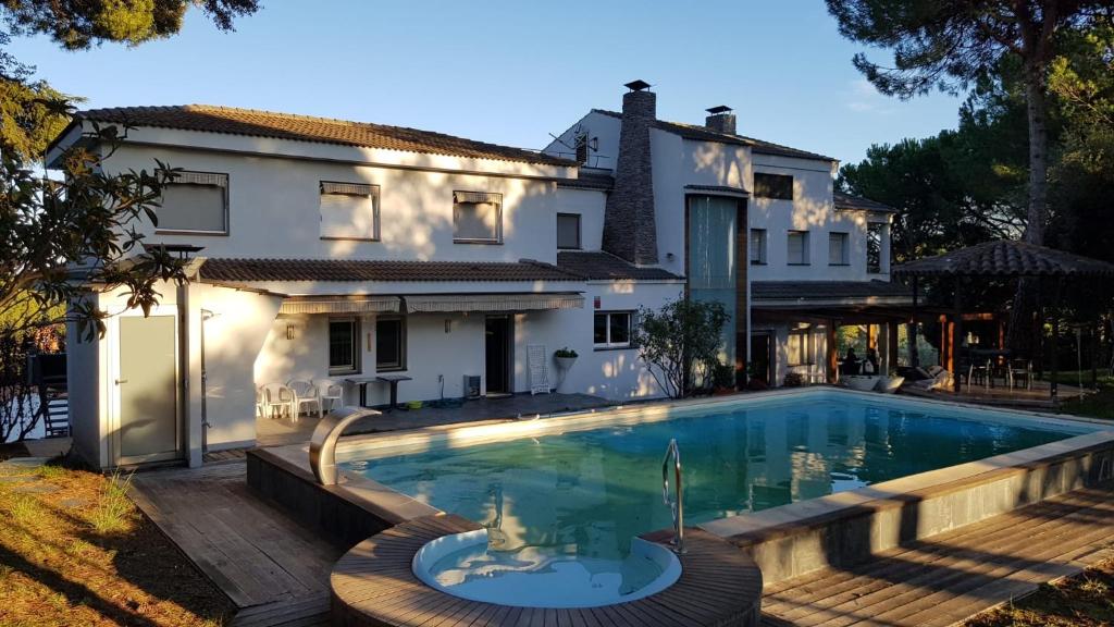 a swimming pool in front of a house at Can Ramón in Caldes de Montbui