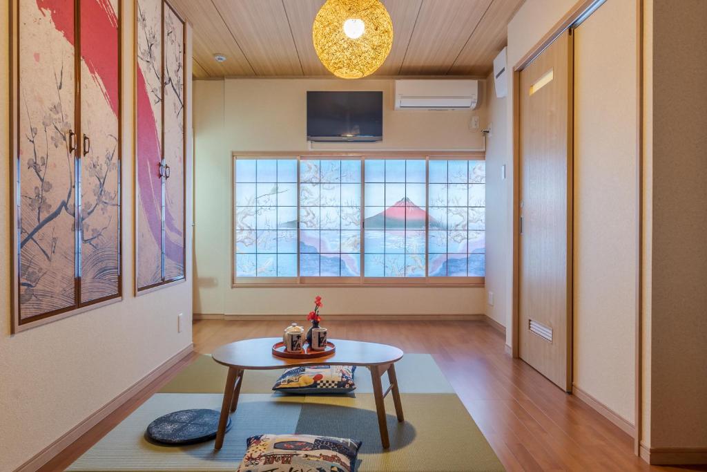 a living room with a table and a window at Re Tokyo II in Tokyo