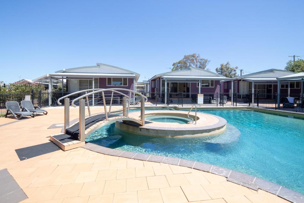 a swimming pool with a pool table and chairs at Ingenia Holidays Hunter Valley in Cessnock